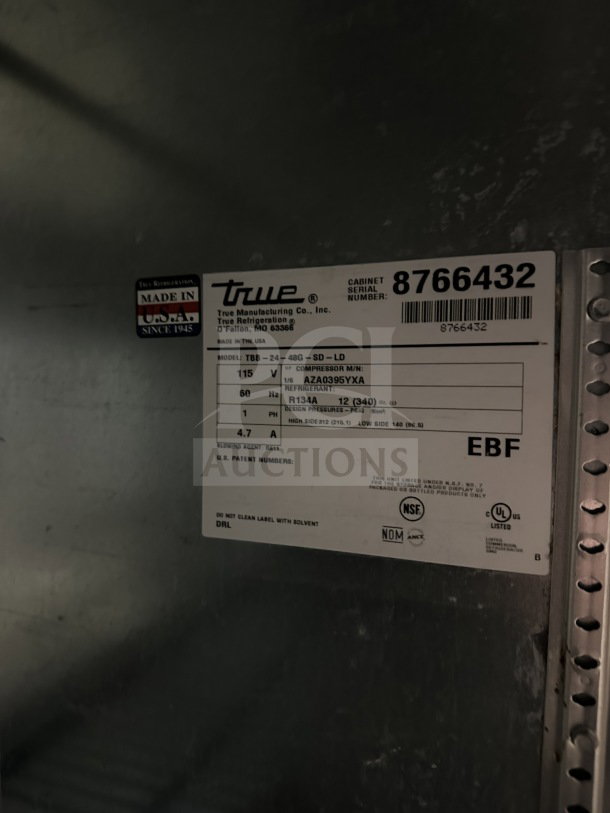 True stainless steel beer back cooler, model TBB-24-48G-SD-LD, with sliding doors, worktop, poly-coated rack. SN: 87664332.