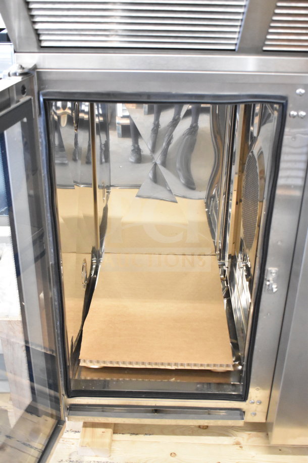Brand new Blodgett BLCT-101 commercial combi oven, electric, with hood. 480V, 3-phase. Showing interior and open door.