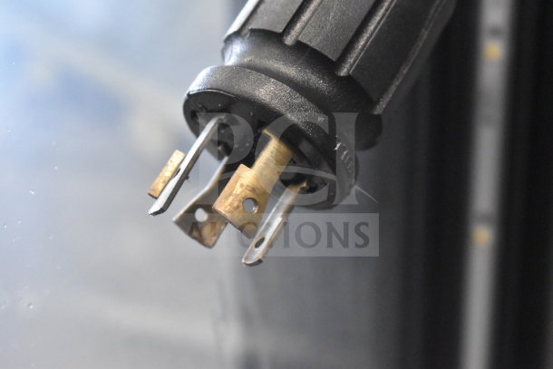 Close-up of electrical plug for 2018 True GDM-72F-HC Commercial Freezer, showing prongs and plug details.