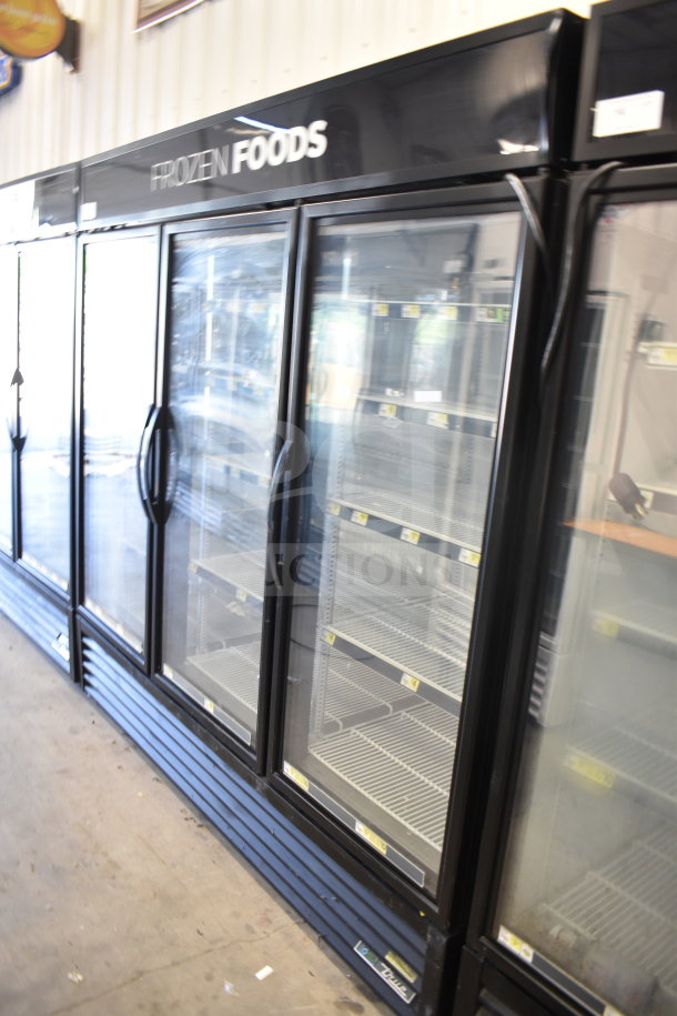 2018 True GDM-72F-HC Commercial 3 Door Reach-In Freezer, black exterior, glass doors, shelving intact, 115/208-230V, 1 Phase.