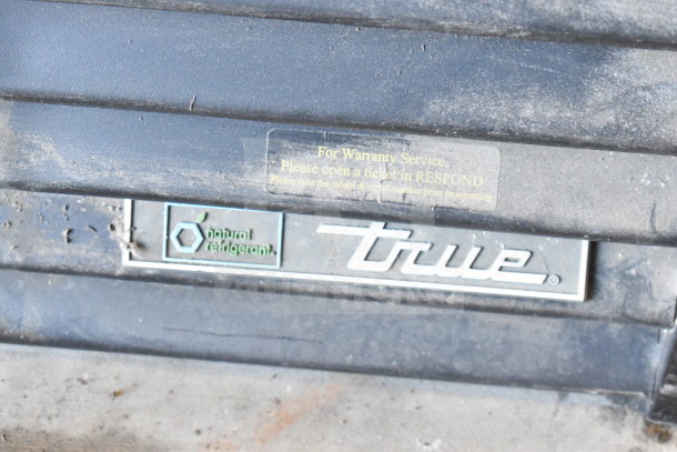 2019 True GDM-72-HC cooler with "natural refrigerant" label and warranty service instructions on front panel.