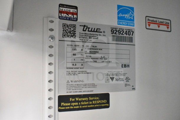 Label inside 2018 True GDM-72-HC 3 Door Cooler shows model, voltage, refrigerant info, and warranty service instructions.