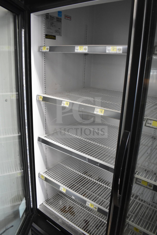 2018 True GDM-72-HC 3-door reach-in cooler with adjustable shelves, visible labels, in good used condition.
