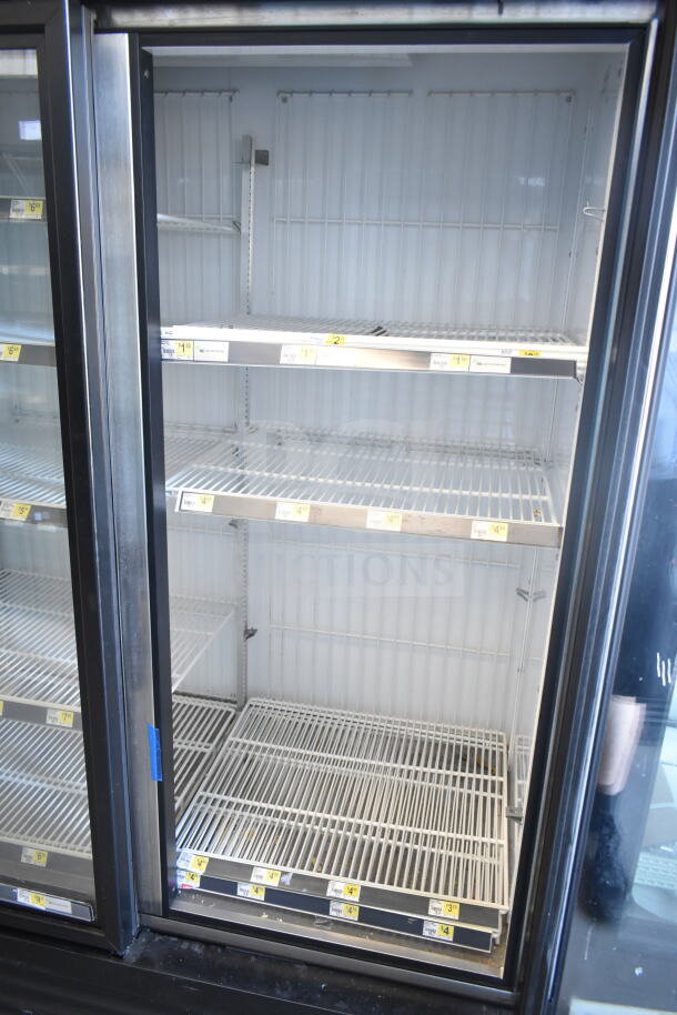 2018 True GDM-72F-HC commercial 3-door reach-in freezer merchandiser, featuring adjustable wire shelves. Model details visible.