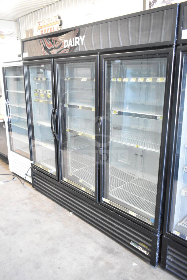 True GDM-72-HC 2018 commercial 3-door reach-in cooler, black frame, glass doors, "Dairy" header, 115V, 1 phase, clean condition.