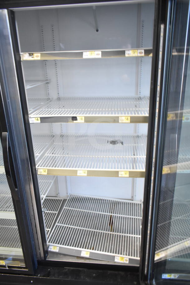 2018 True GDM-72-HC commercial 3-door cooler merchandiser. 115 volts, 1 phase. Clean, spacious shelves visible.