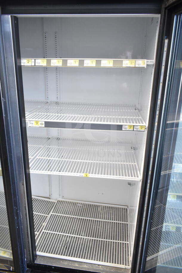 2018 True GDM-72-HC commercial 3-door cooler, empty shelves, 115 volts, 1 phase, ideal for retail refrigerated display.