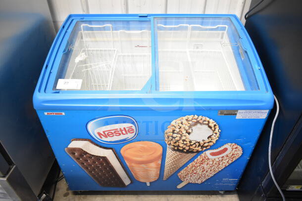 Commercial chest freezer merchandiser on casters, 115 volts, 1 phase, branded with Nestlé ice cream images.