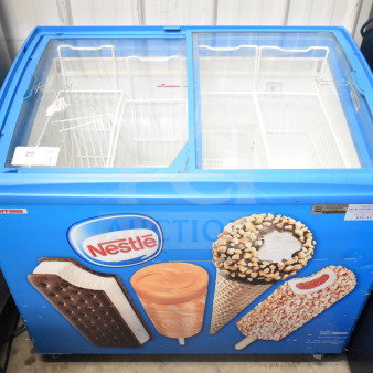 Commercial chest freezer merchandiser on casters, 115 volts, 1 phase, branded with Nestlé ice cream images.