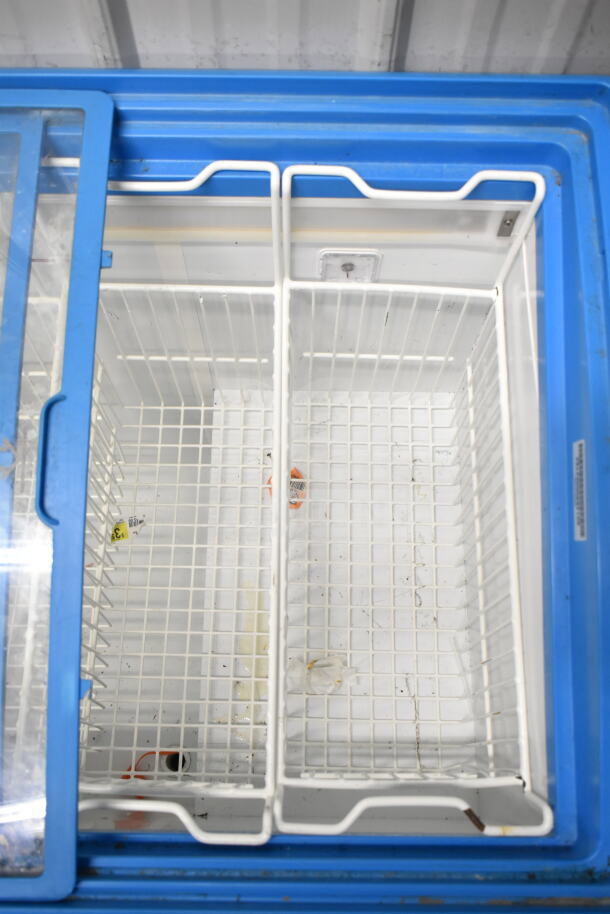 Commercial chest freezer merchandiser with dual compartments and sliding glass doors on commercial casters. 115V, 1 Phase.