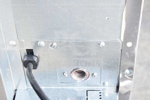2025 Hoshizaki AM-50BAK ice machine, power cable and metal connections visible. Features undercounter design, 54 lb. capacity.