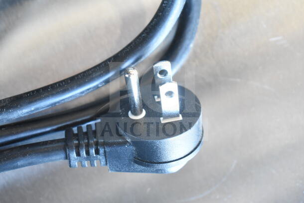 Close-up of a power plug for the Hoshizaki AM-50BAK ice machine, showing a standard three-prong plug.