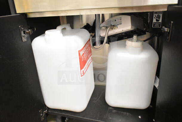 Ozark River Portable Sink under cabinet view showing two white water tanks and plumbing components, commercial-grade quality.