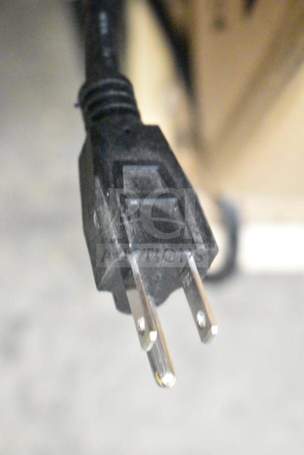 Close-up of a power plug for a Carnival King Oasis 2-10 frozen beverage machine, indicating its electrical compatibility.