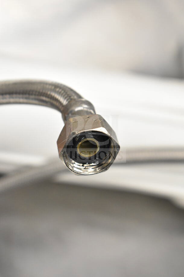 Hoshizaki KM-151BAH ice machine water hose detail, showing connector with metallic finish, indicating good condition.