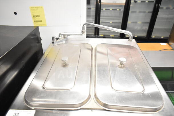 Taylor 754-33 commercial soft serve machine, water-cooled, two flavors with twist. Shown on commercial casters, stainless steel top.