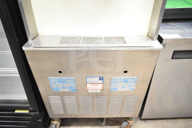 Taylor 754-33 floor style, water-cooled, 2-flavor ice cream machine on casters. 208-230V, 3 phase. Visible caution label.