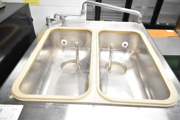 Taylor 754-33 water-cooled soft serve machine with dual flavor and twist options. Features commercial casters.
