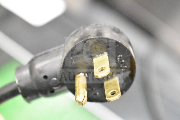 Close-up of a plug attached to the 2023 Delfield 406P-STAR2 Undercounter Cooler, 115 volts, 1 phase.