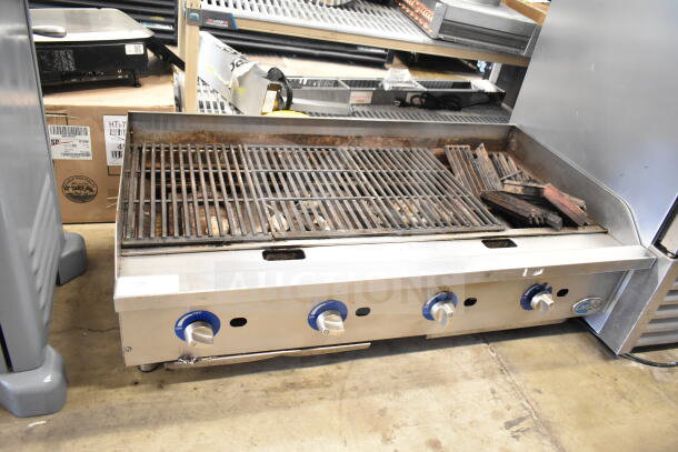 Globe commercial countertop gas charbroiler grill with four knobs, stainless steel body, used condition, visible wear.