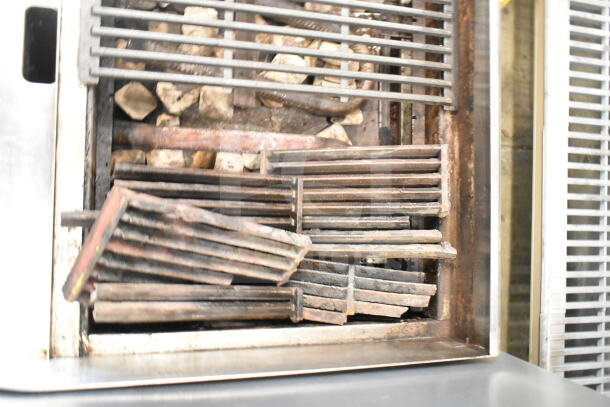 Globe Commercial Countertop Gas Charbroiler Grill, showing metal grates and stone, used condition, ideal for restaurants.