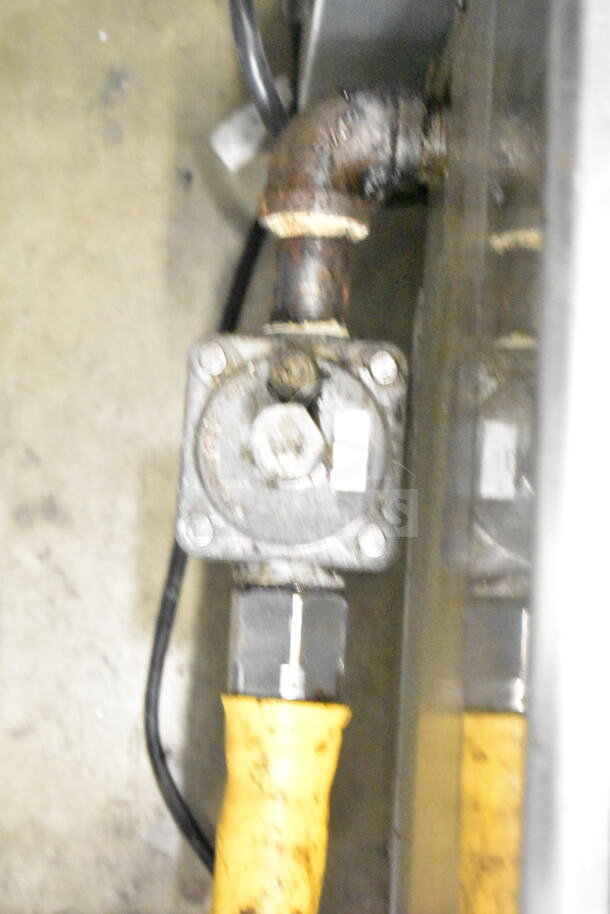 Globe commercial countertop gas charbroiler grill with visible gas connection; used condition showing rust and wear.