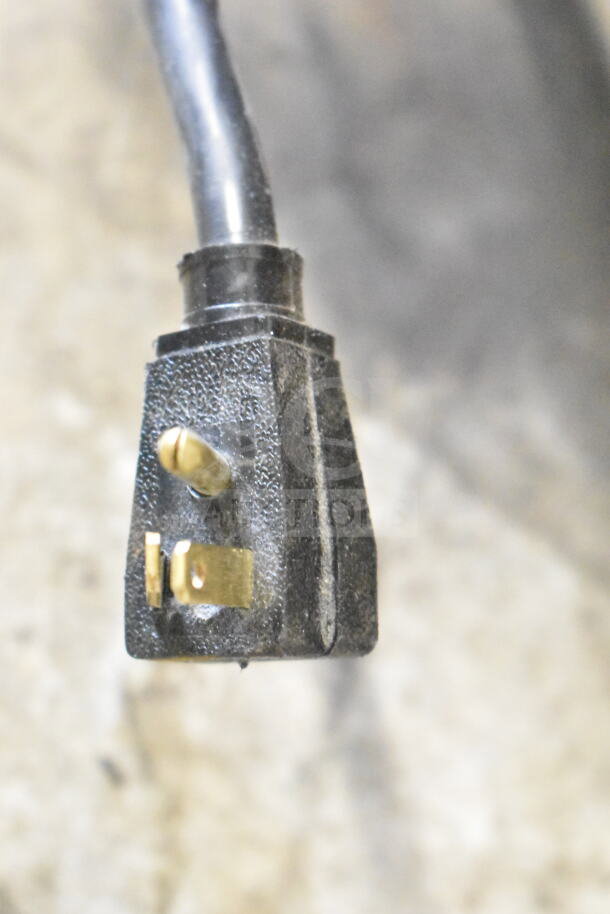 Close-up of black electrical cord plug for 2022 True T-35G-HC Cooler, 115 Volts, 1 Phase.