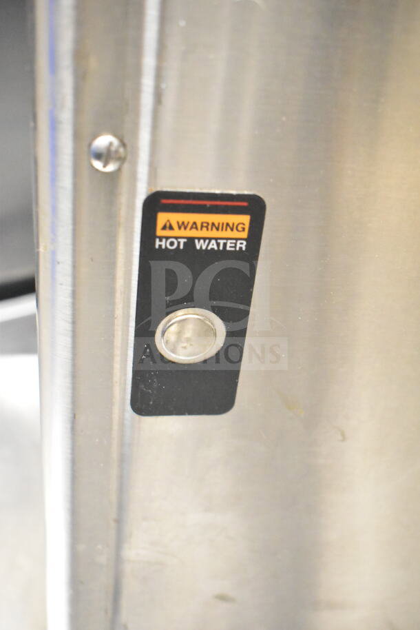 Bunn ICB-DV coffee machine detail showing "Warning Hot Water" label on stainless steel body.