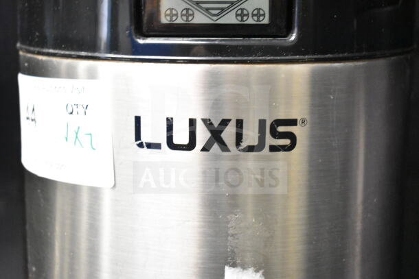 Luxus countertop coffee holder dispenser, stainless steel, visible Luxus logo, auction tag showing item number.