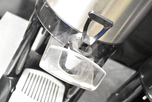 2 Luxus countertop coffee holder dispensers. Stainless steel and black finish. Includes easy-release lever. Good condition.