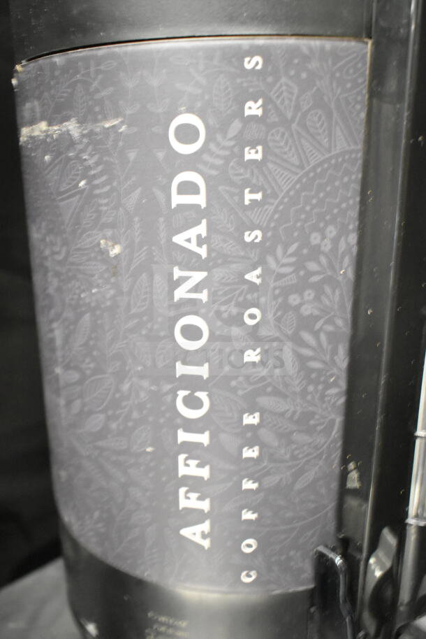 2 Luxus countertop coffee holder dispensers, labeled "AFFICCIONADO COFFEE ROASTERS". Slight wear visible.