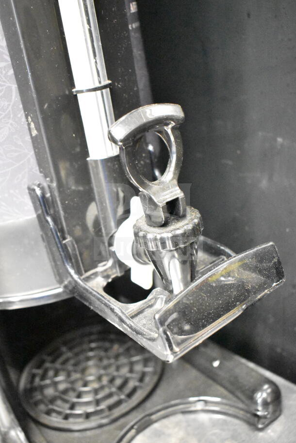 2 Luxus countertop coffee dispensers, black, durable plastic, spout design, used condition, ideal for commercial use.