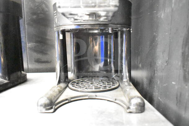 2 Luxus countertop coffee holder dispensers, black, sturdy design, slight wear. Ideal for efficient coffee service.