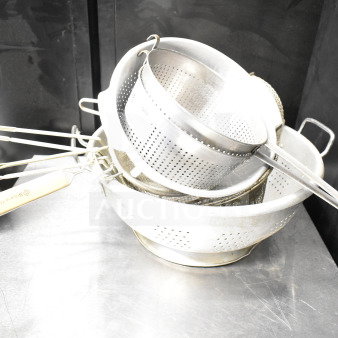 Eight kitchen items including colanders and strainers, metal construction, stackable, gently used condition.