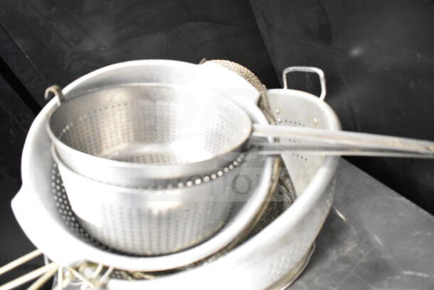Metal kitchenware set including colanders and strainers, stacked. Used condition. Bid increases eightfold.