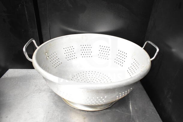 Metal colander with side handles, perforated for draining. Part of a set of 8 various kitchen items.