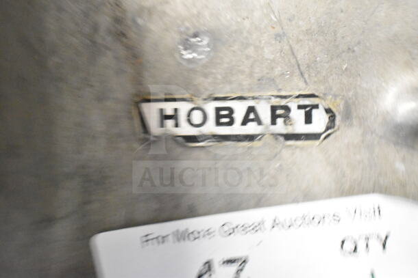 Hobart pelican head with grating blade, used condition, visible wear. Manufacturer label indicates Hobart branding.