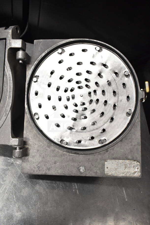 Pelican head with grating blade, metallic finish, circular perforated surface, used condition, industrial kitchen equipment.