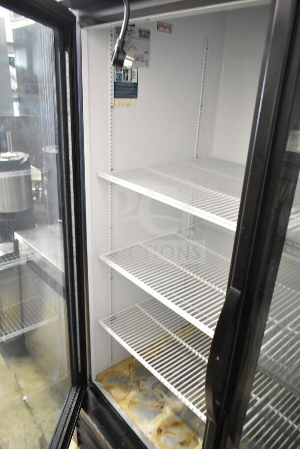 2019 True GDM-49-HC cooler, commercial 2-door reach-in, 115V, worn interior shelves, visible plug.