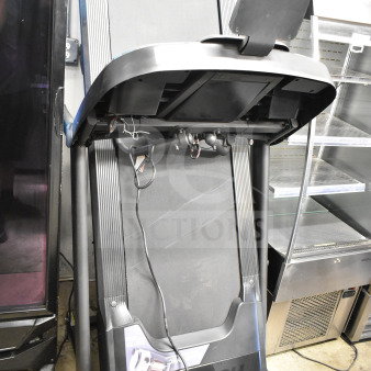 Horizon folding treadmill in good condition, black with visible power cord. Compact design, suitable for limited spaces.