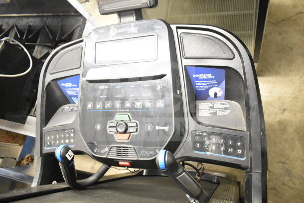 Horizon Folding Treadmill control panel with Bluetooth, speed, incline settings, and immersive experience labels visible.