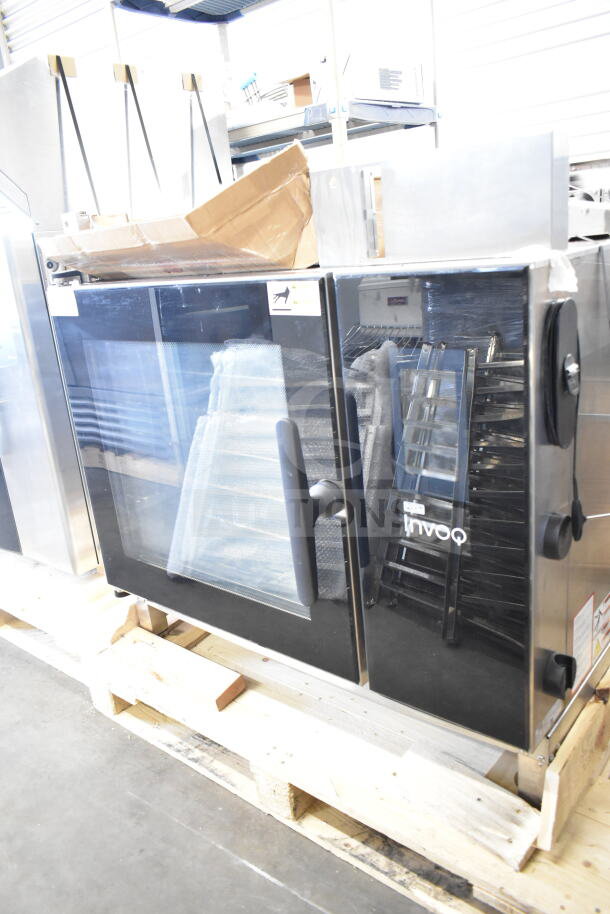 Brand new Blodgett Invoq commercial combi convection oven with minor scratches and dents, visible through glass door.