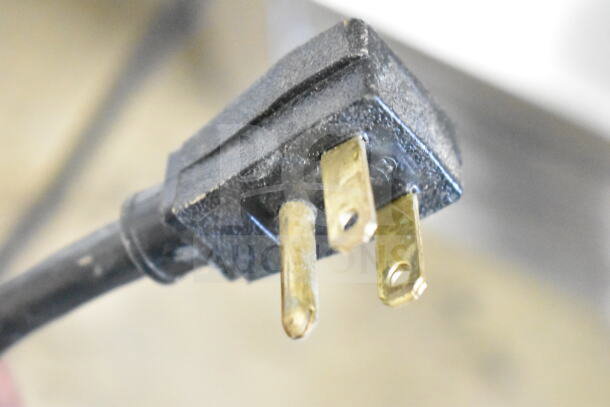 Close-up of a power plug for the 2016 True T-49F Commercial 2 Door Reach In Freezer, showing three prongs.