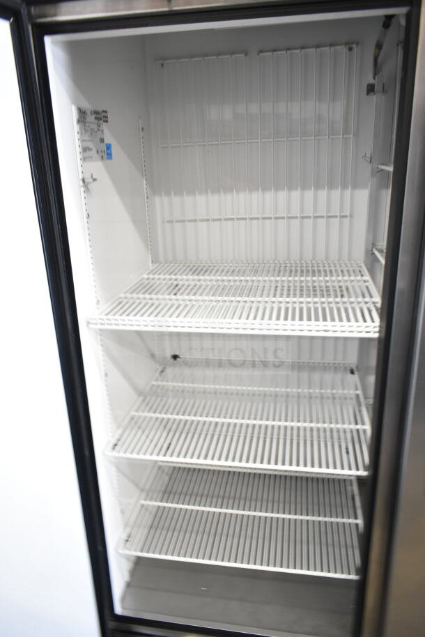 True T-49F Commercial 2 Door Reach In Freezer. White interior with wire shelving. Tags showing model and electrical details.