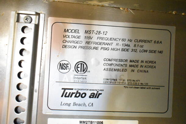 Turbo Air MST-28-12 label with specs: 115V, 60Hz, 6.6A, refrigerant R-134a. NSF and ETL listed, components from Korea, assembled in China.