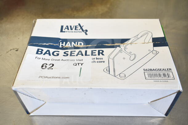 Brand new Lavex 562BAGSEALER bag sealing tape dispenser in box with scratch and dent. Box shows tape, markings, and damage.