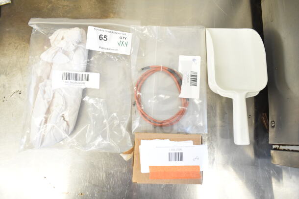 Four new items: ignition wire, combo latch, Vitamix blade, scooper. Items in packaging with visible barcodes, in scratch and dent condition.