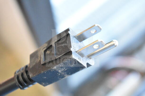Close-up of a power plug from a Carnival King 382PM30R popcorn machine, showing cord condition and plug prongs.