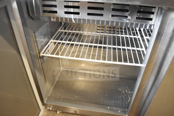 Avantco 178SSPT48MHC commercial prep table interior, metal shelves, clean condition, label with model details visible.