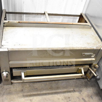 Jade gas-powered commercial cheese melter in used condition, metal finish, with visible control knob and Jade branding.